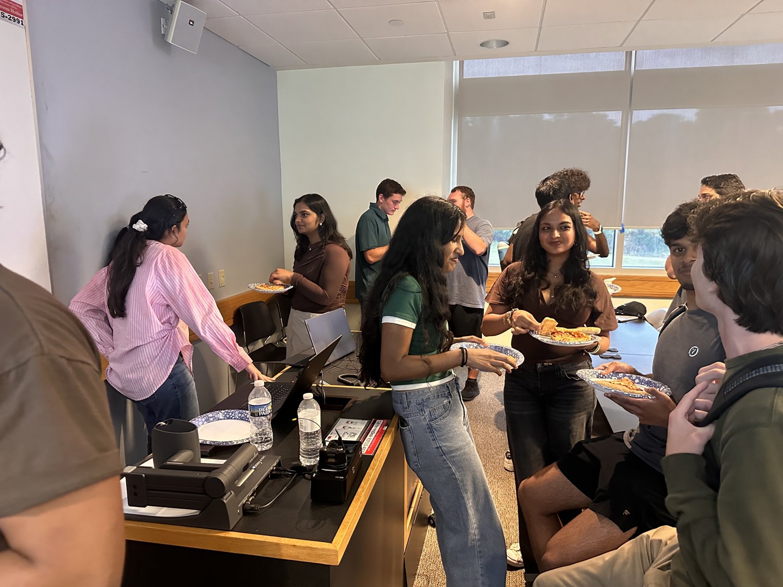 Students chatting over food at the ACM interest meeting